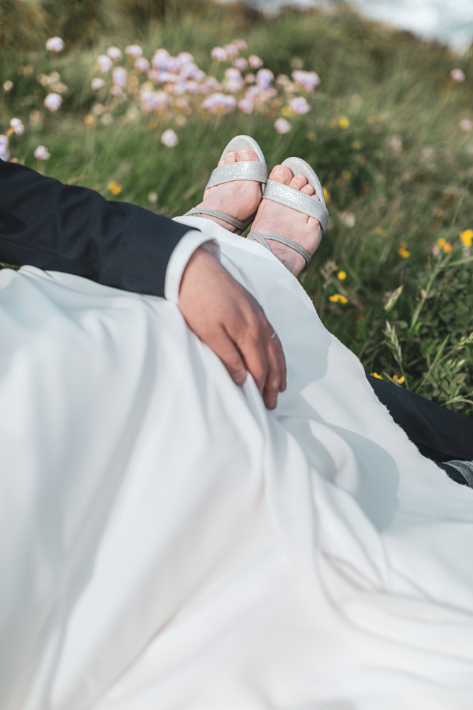 couple dans l'herbe, chaussures de la mariée