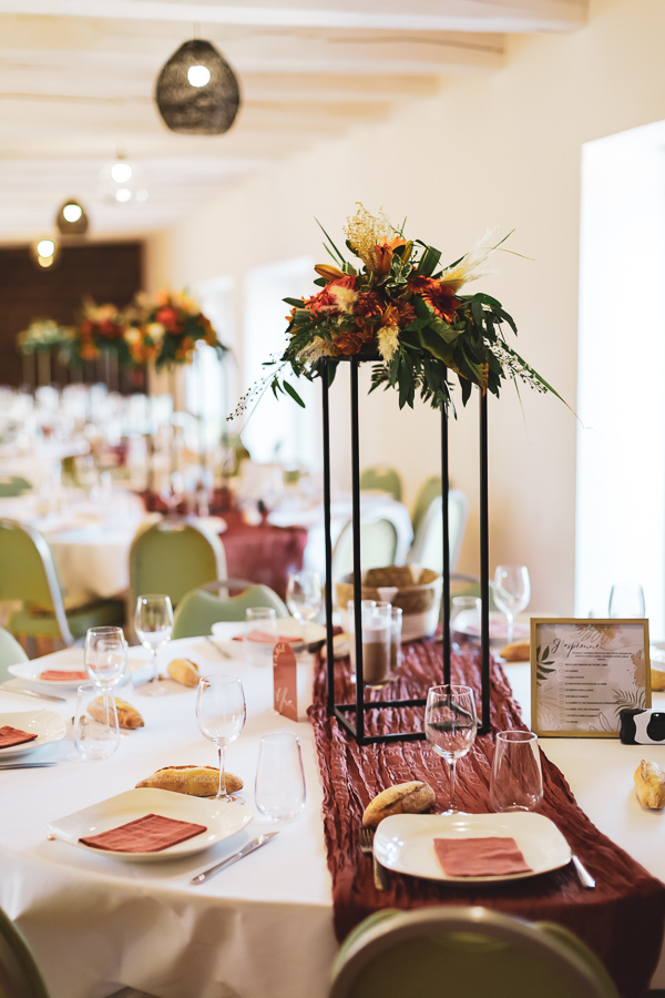 Décoration des tables avec des chemins de tables terra cotta et sauge et bouquet coloré à L'eau des collines