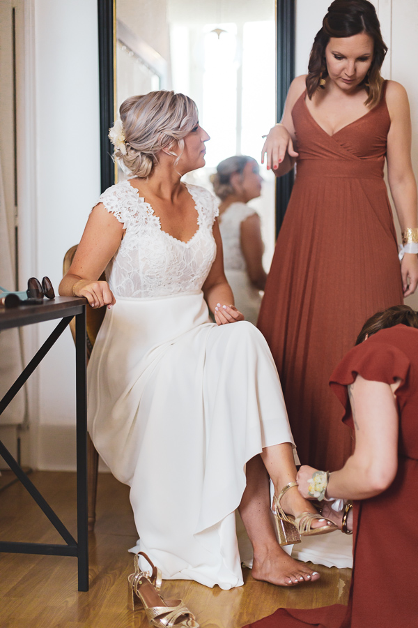 les témoins aident la mariée à s'habiller et mettre ses chaussures