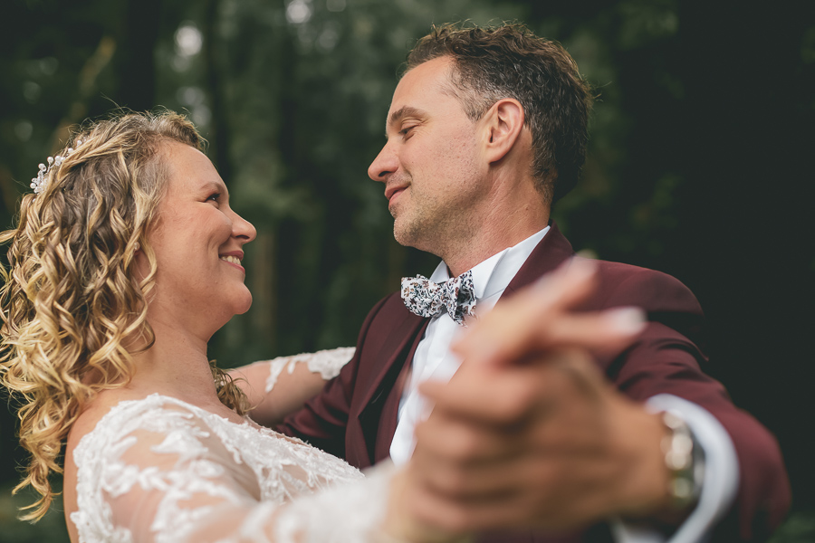 Les mariés dansent, se regardent et sourient de bonheur et d'amour