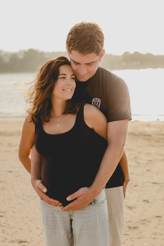 couple enlacé amoureux mains sur lee ventre grossesse coucher de soleil